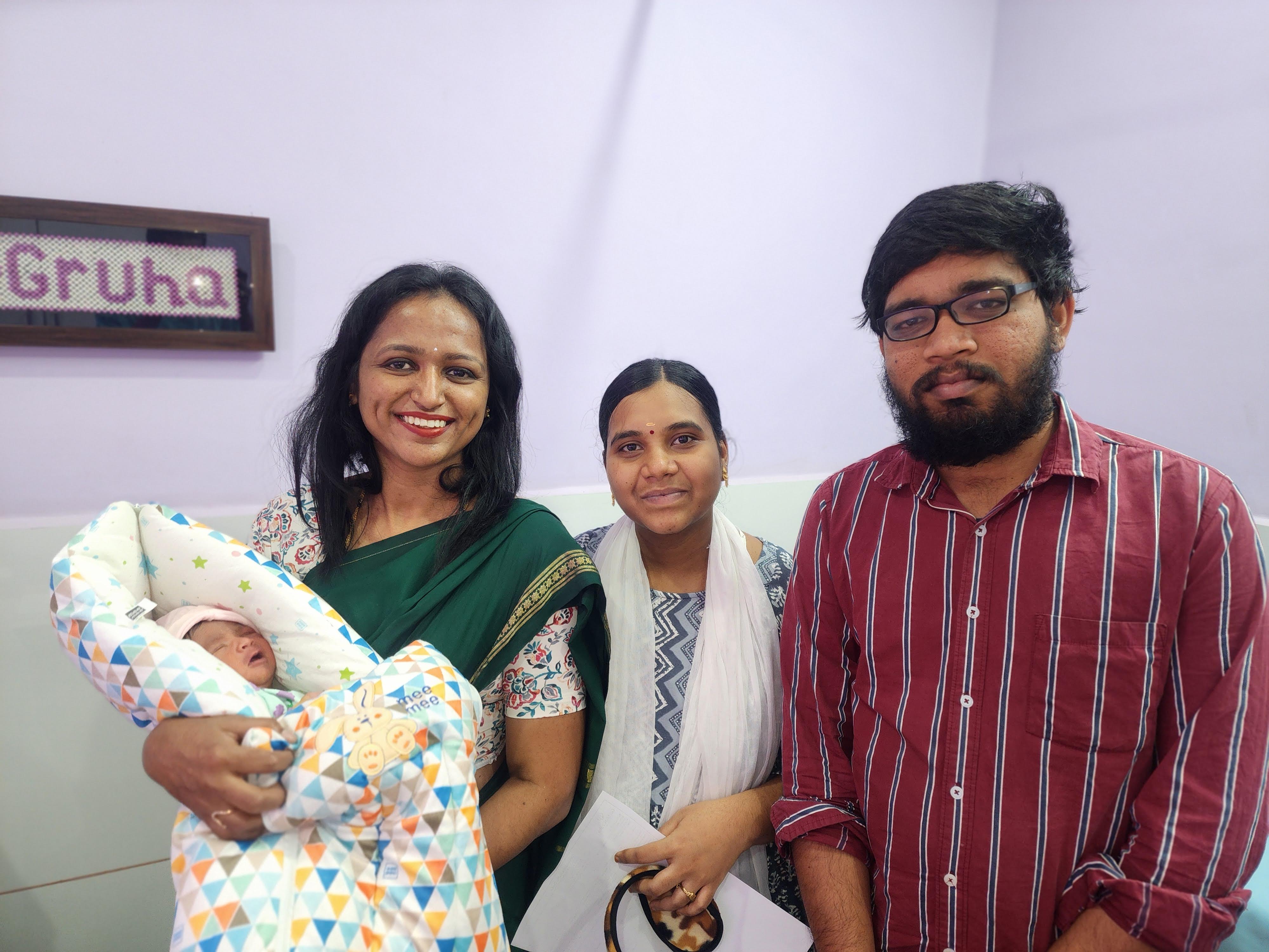 Dr. Rashmi T N with a newborn and new parents at GarbhaGruha Health Center, Bangalore